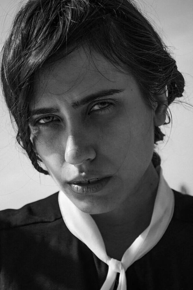Fine-art black and white portrait of a woman with a white collar
